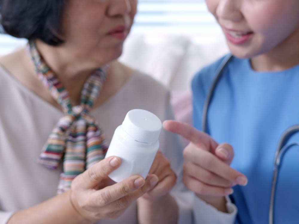 Nurse showing client medication